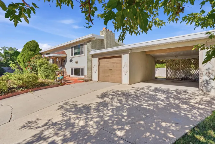 Attached single-car garage, covered carport, and concrete driveway