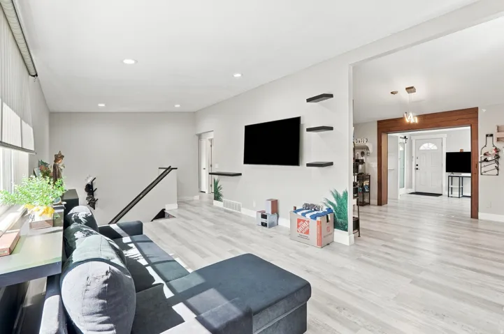 Recessed lighting throughout, wood-finish flooring, and a framed entryway