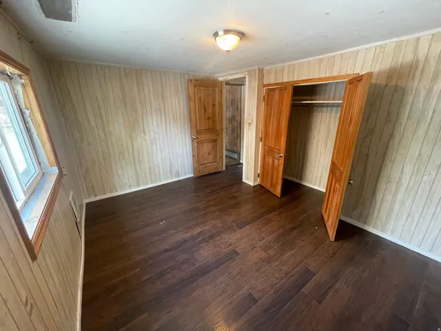 Wood-finish flooring with light-toned paneled walls