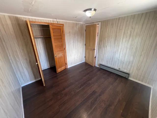 Wood-finish flooring with light-toned wall paneling