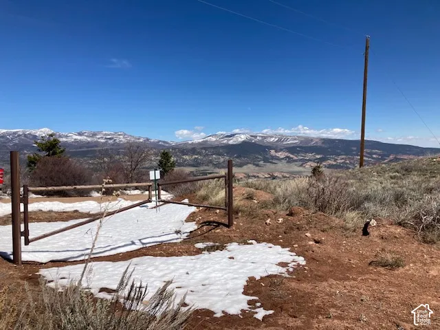 Mountain range backdrop with expansive valley and clear blue sky