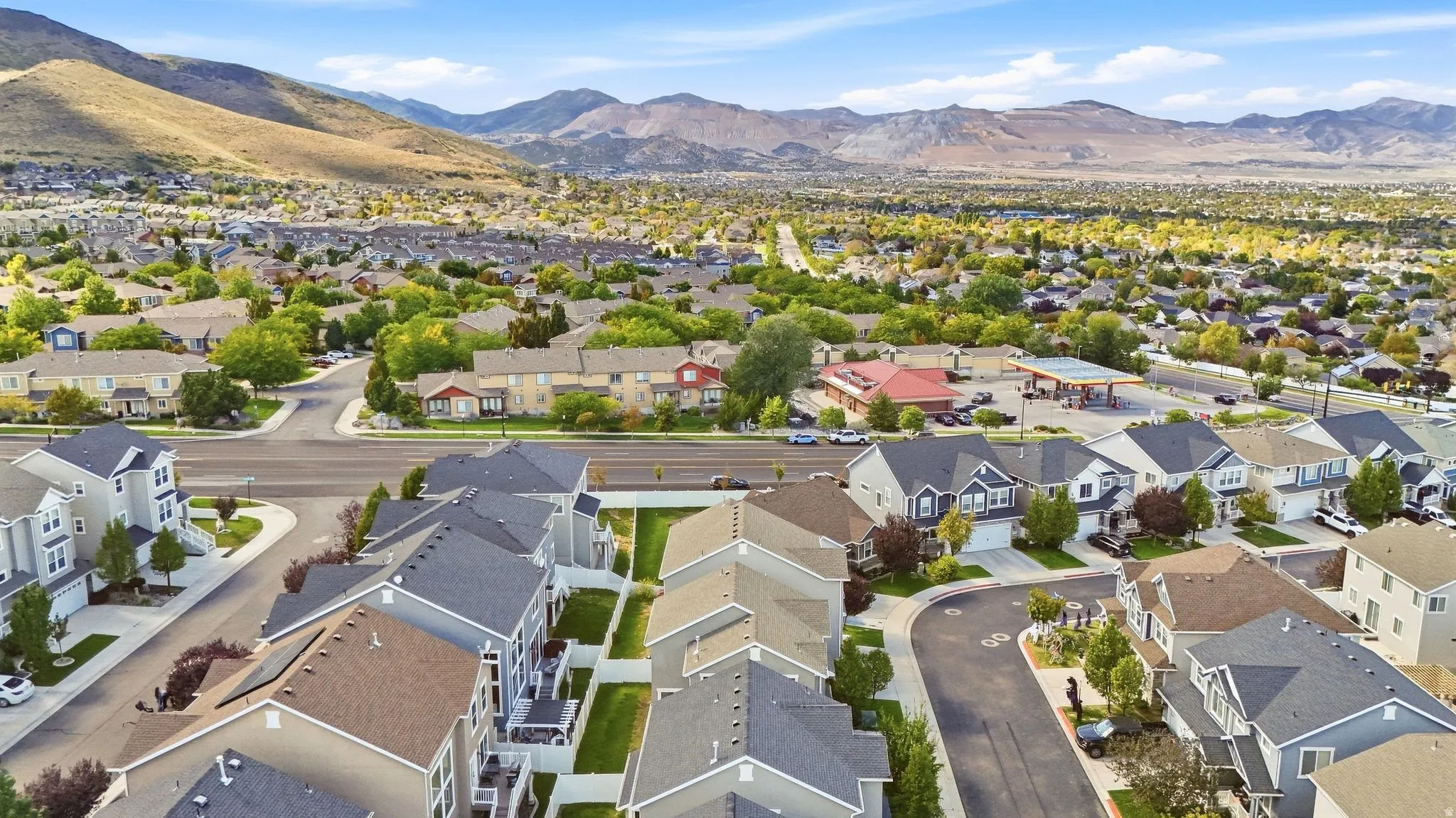 Mountain backdrop, residential development, tree-lined streets, paved roadways, cul-de-sac
