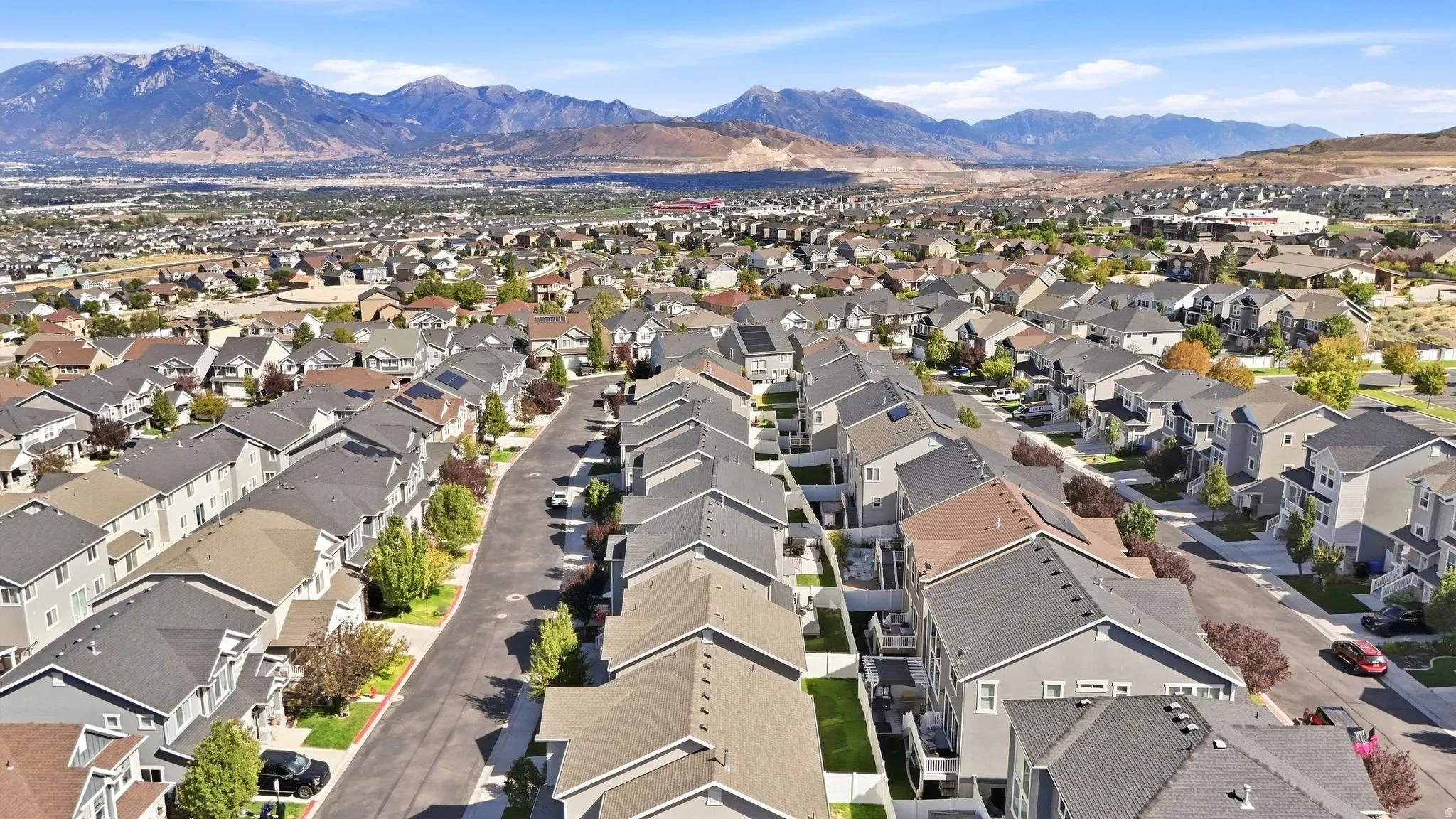 Expansive residential development featuring uniform rooflines and a mountainous backdrop