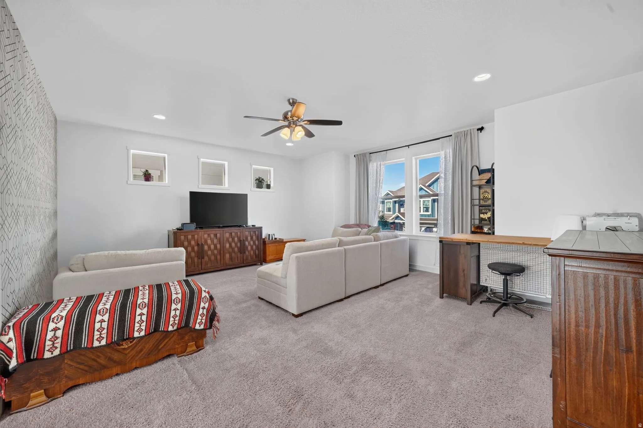 Recessed lighting, ceiling fan, carpeting, built-in desk, and window with exterior view