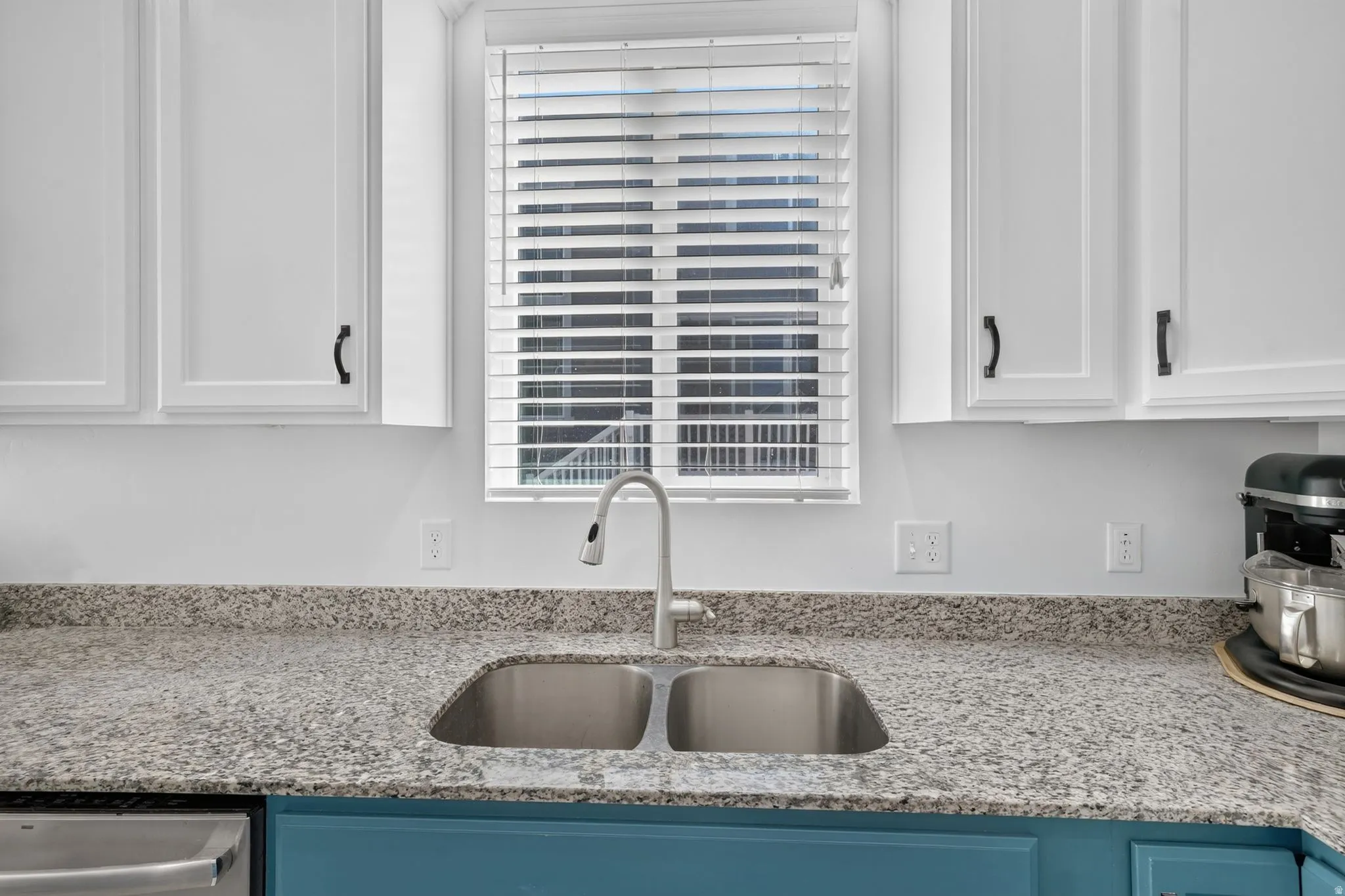 Dual-basin stainless steel sink with a gooseneck faucet