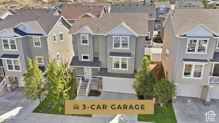 Three-story stucco exterior with white trim