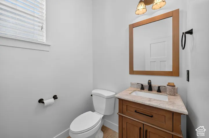 Wood-finish vanity with an integrated sink and stone countertop