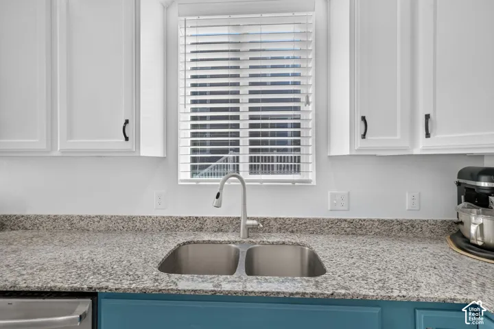 Dual-basin stainless steel sink with a gooseneck faucet