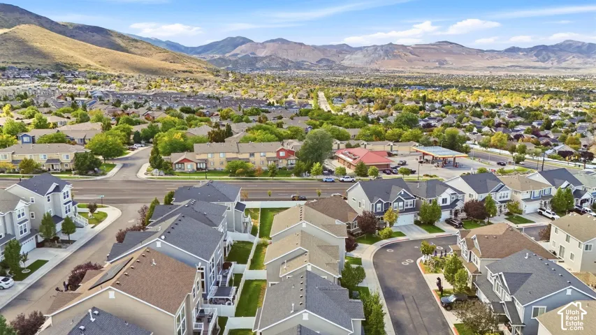 Mountain backdrop, residential development, tree-lined streets, paved roadways, cul-de-sac