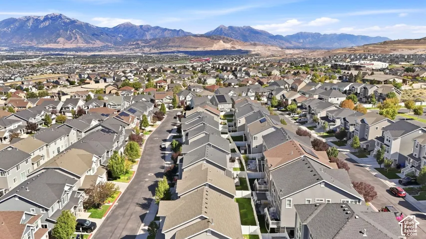 Expansive residential development featuring uniform rooflines and a mountainous backdrop