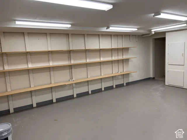 Room with painted walls, multiple overhead lighting fixtures, and light gray flooring