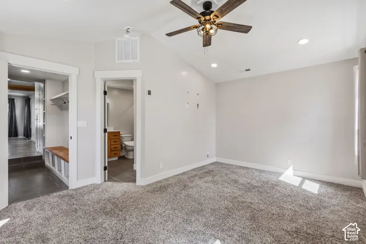 Carpeted room featuring a ceiling fan with integrated lighting, recessed lighting, and a vaulted ceiling