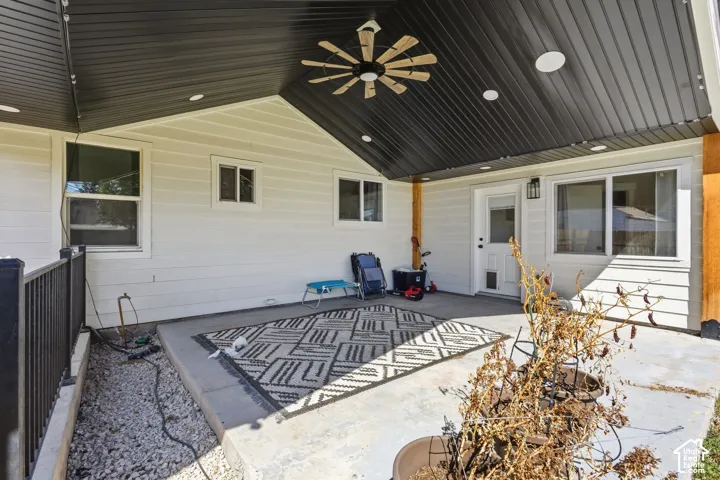 Covered patio featuring a wood-tone ceiling fan and recessed lighting
