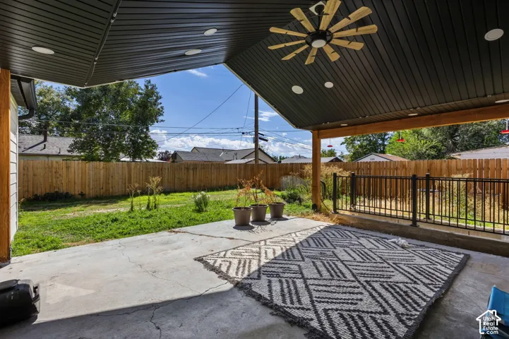 Covered patio featuring a ceiling fan, recessed lighting, and wood beams