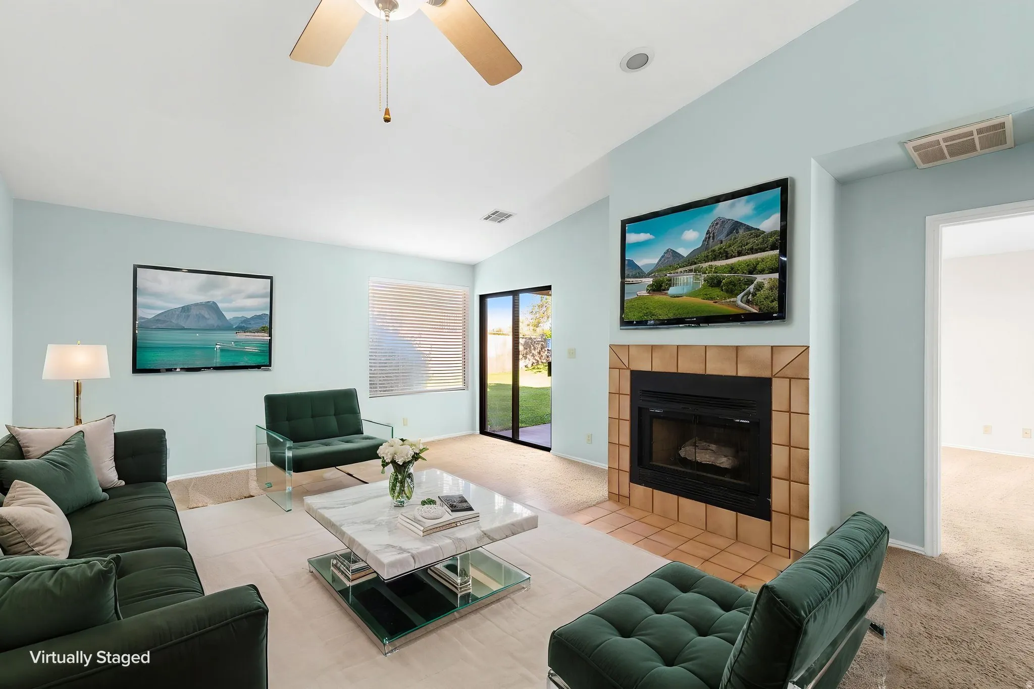 Living area with a ceiling fan, recessed lighting, and a tiled fireplace