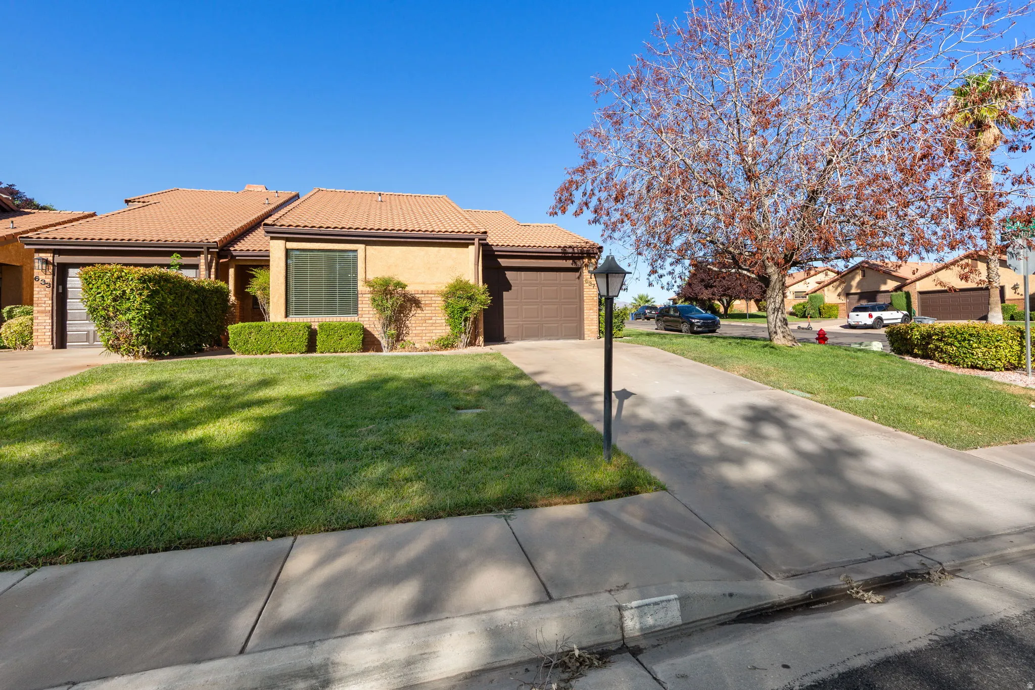 Property exterior with roof tiles, stucco finish, and an attached garage