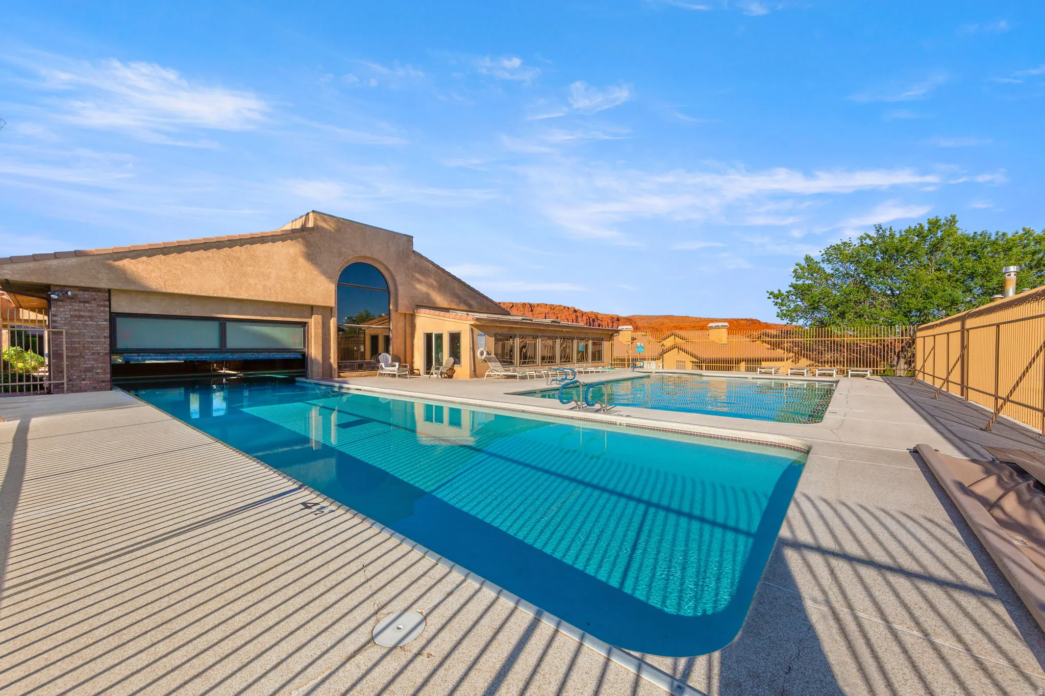 Resort-style outdoor pool with extensive concrete decking.