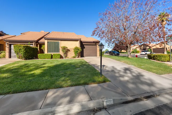 Property exterior with roof tiles, stucco finish, and an attached garage