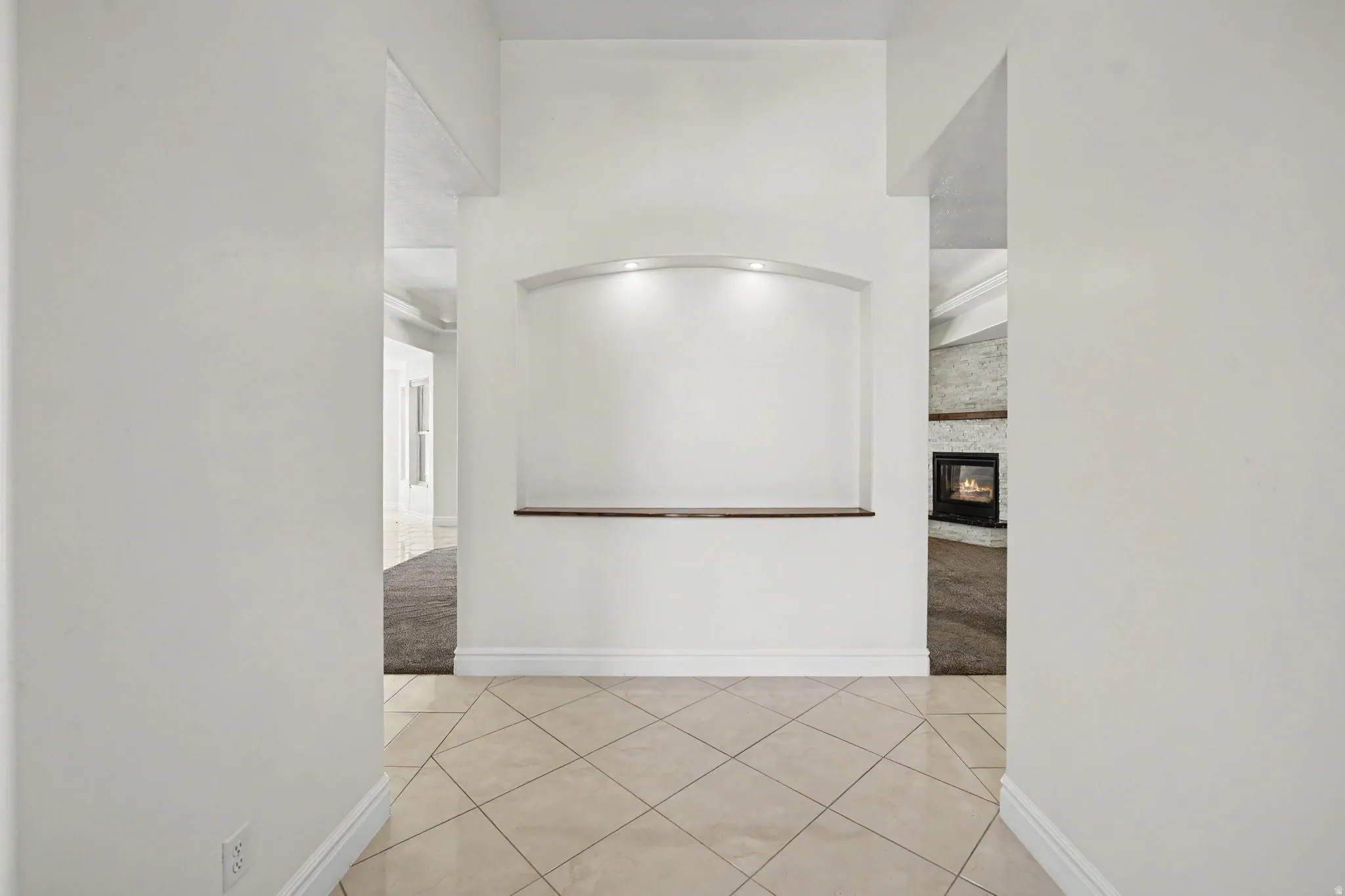 Recessed wall niche with integrated lighting and a wood-finish shelf