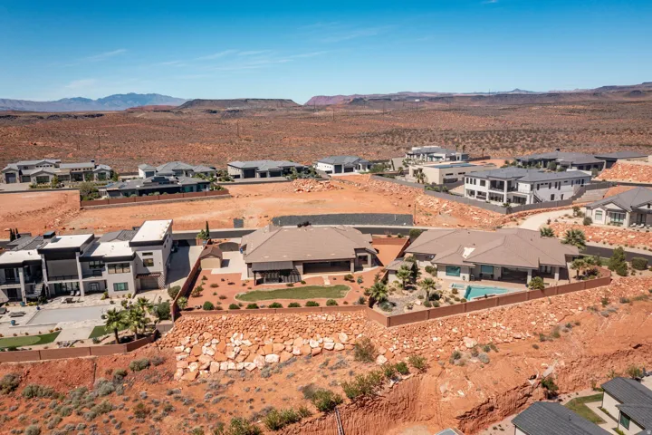 Residential neighborhood featuring diverse architectural styles, mature desert landscaping, and a clear desert sky