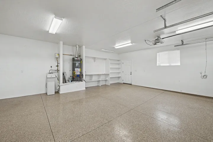 Epoxy coated flooring, built-in shelving, white walls, and fluorescent overhead lighting