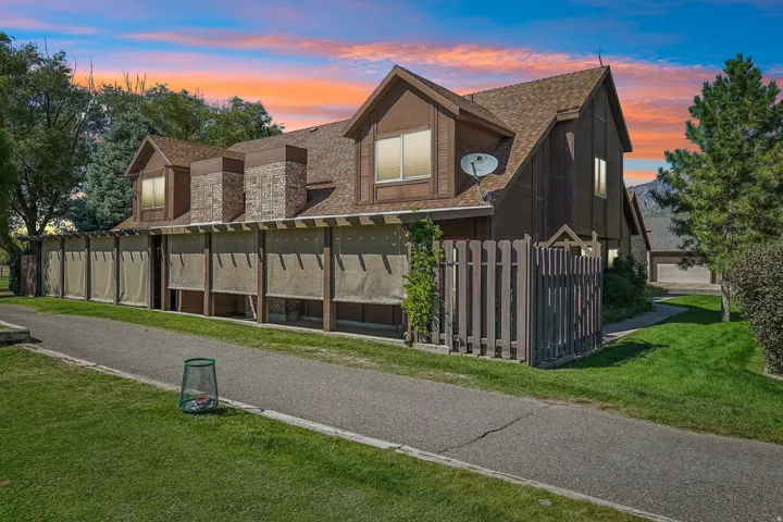 Multi-level exterior with dormer windows and a shingle roof