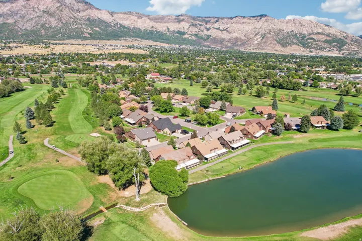 Mature residential community with mountain backdrop, established golf course, and a tranquil pond feature