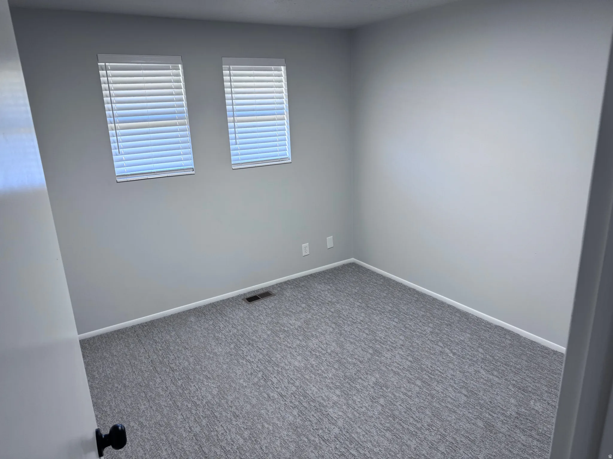 Light gray walls complemented by gray patterned carpeting