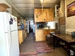 Kitchen with wood-finish cabinetry, a ceiling fan, and overhead lighting