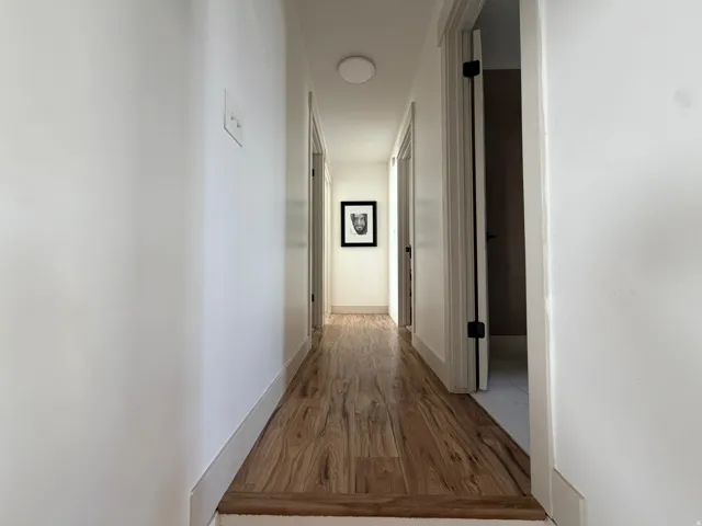 Wood-finish flooring throughout the hallway