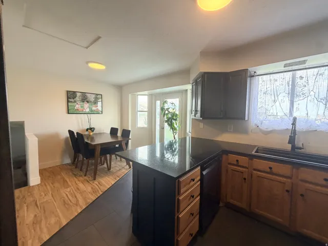 Kitchen featuring dark cabinetry, a black sink with a matte black faucet, and a black countertop