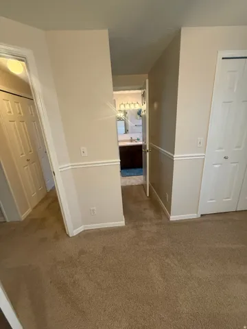 Carpeted flooring with neutral wall tones and white trim