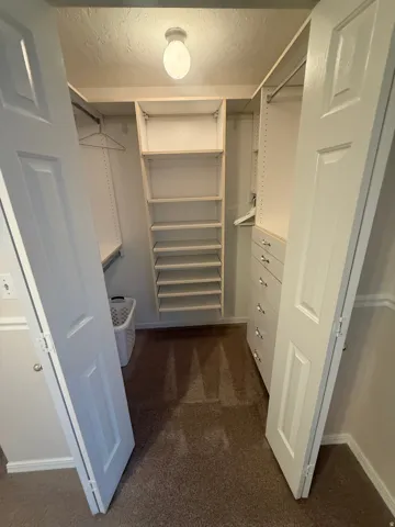 Customizable closet system with built-in shelving, hanging rods, and drawer storage