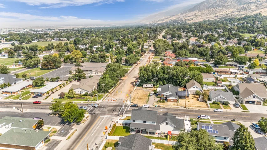 Residential neighborhood with mature trees and mountain backdrop