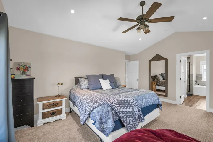 Master Bedroom Vaulted ceiling with a ceiling fan, recessed lighting, carpet flooring, and a double-door entry to an adjoining bathroom