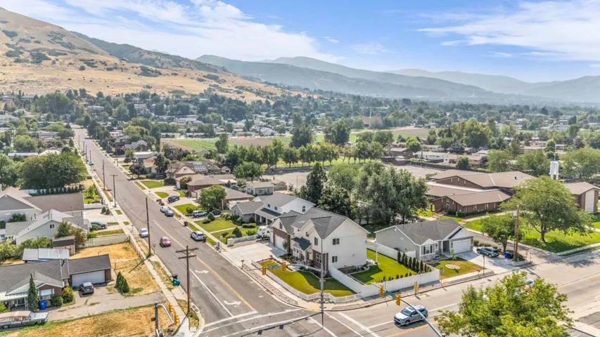 Mountain backdrop with established neighborhood, featuring residential properties and tree-lined streets