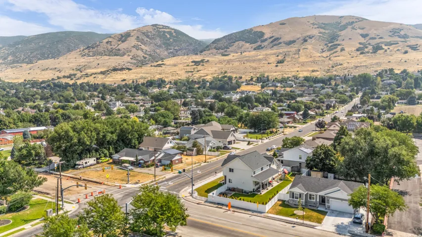 Residential area with established trees and mountain backdrop