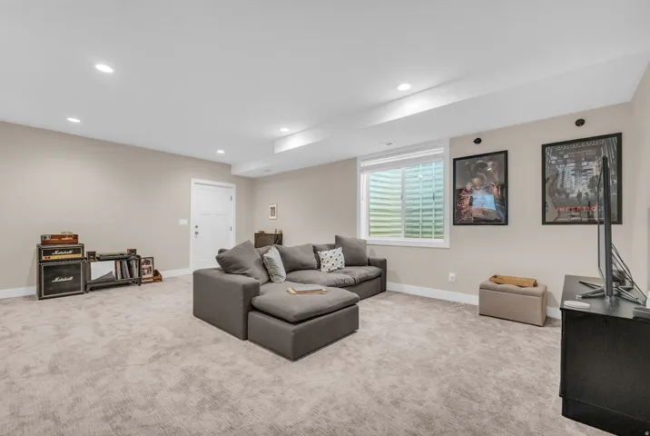 ADU Recessed ceiling lighting, neutral-toned walls, and soft carpeting