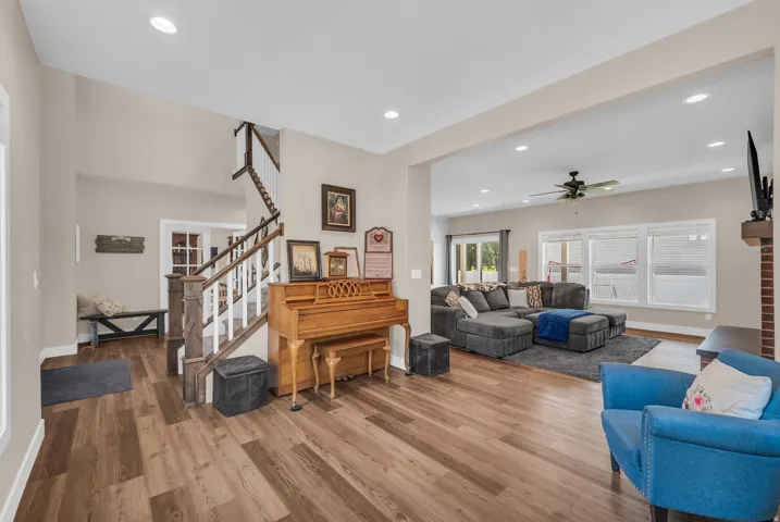 Wood-finish flooring, recessed lighting, and a multi-pane window provide a bright interior