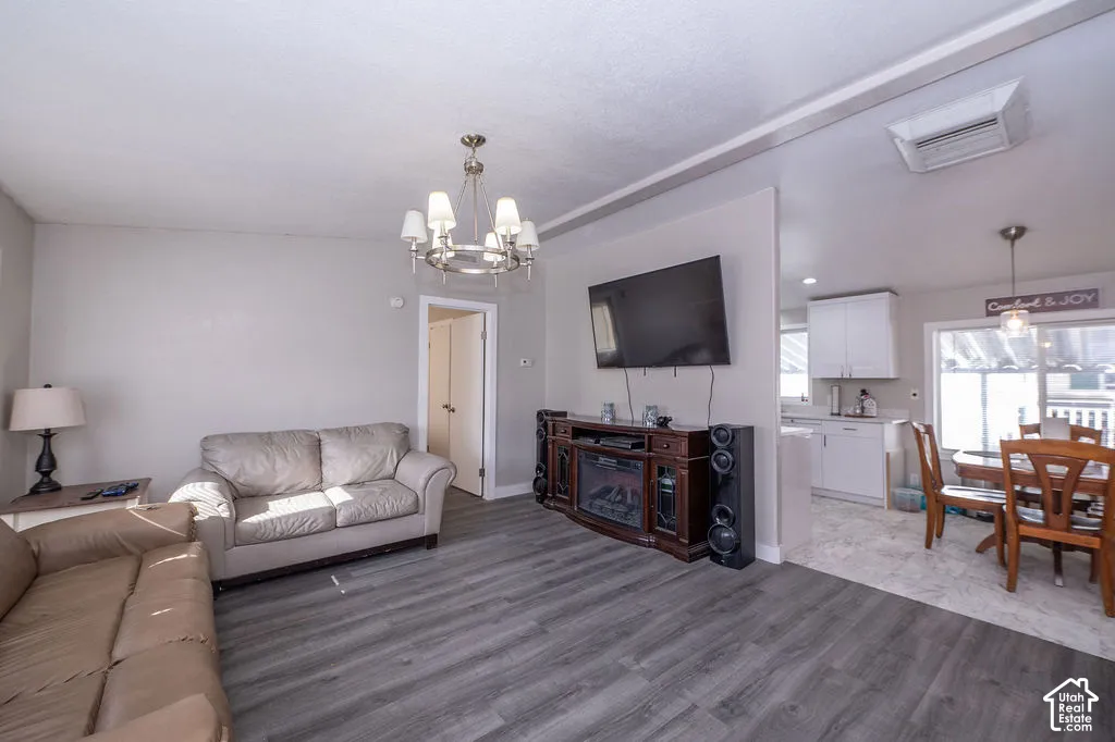 Wood-finish flooring throughout, complemented by a contemporary chandelier