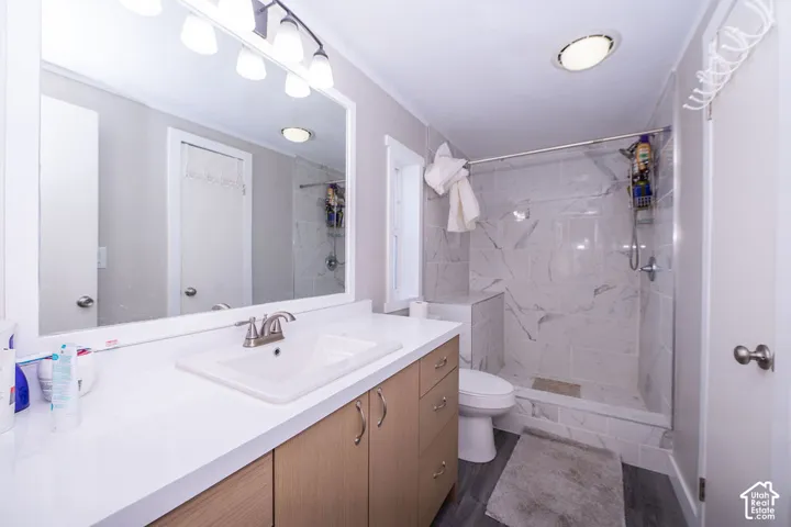 White countertop vanity with wood-finish cabinetry