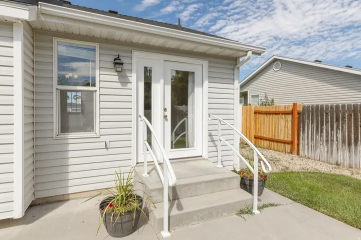 White vinyl siding exterior with an attached outdoor wall lantern