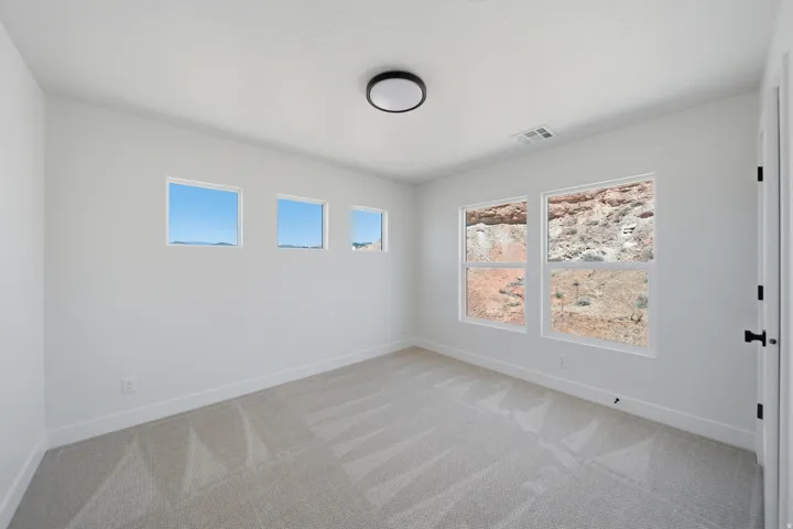 Neutral wall color with patterned carpet flooring
