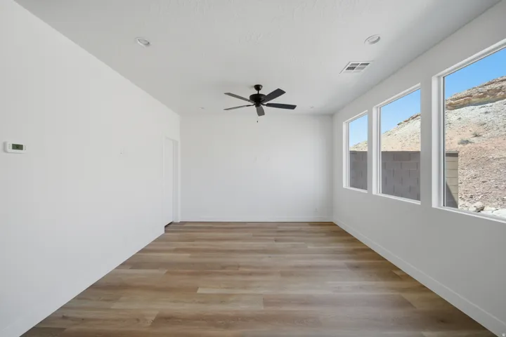 Wood-finish flooring, recessed lighting, and a ceiling fan
