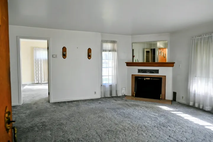 Built-in fireplace with wood-finish mantel and integrated mirror
