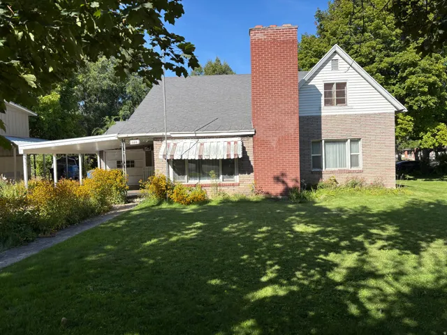 Brick and siding exterior with a prominent brick chimney