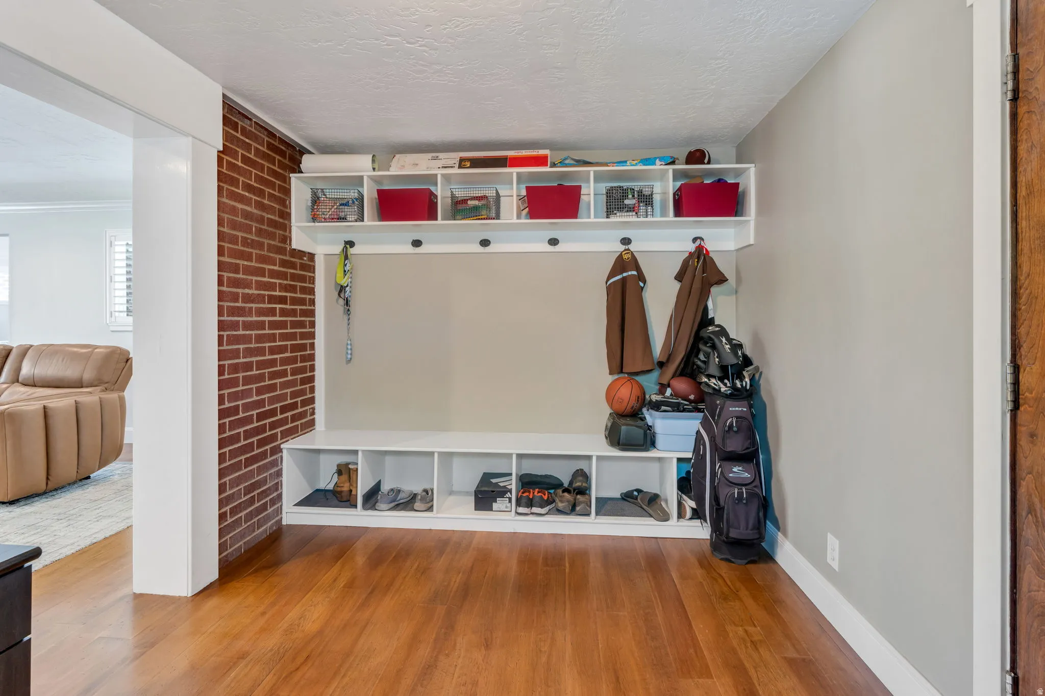 Built-in storage bench with cubbies, overhead shelving, and coat hooks