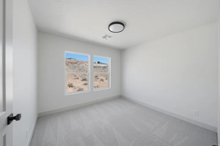 Recessed lighting, light gray textured carpeting, white walls, and dual pane windows