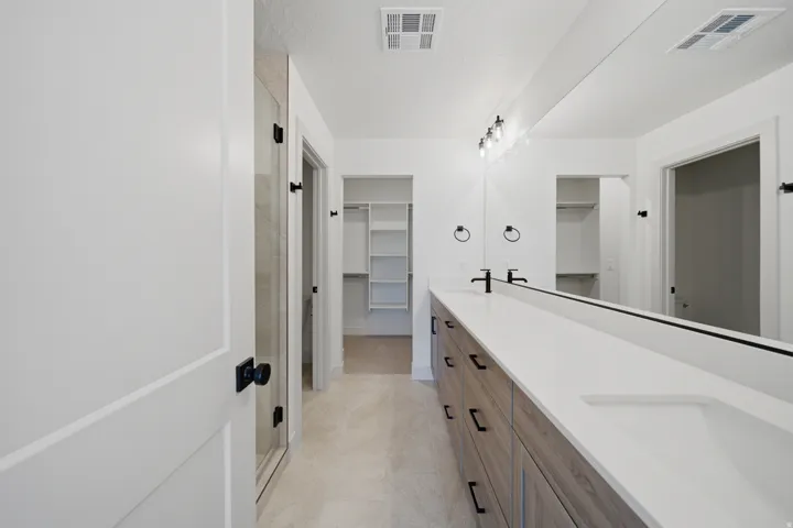 Double vanity with integrated sinks and wood-finish cabinetry