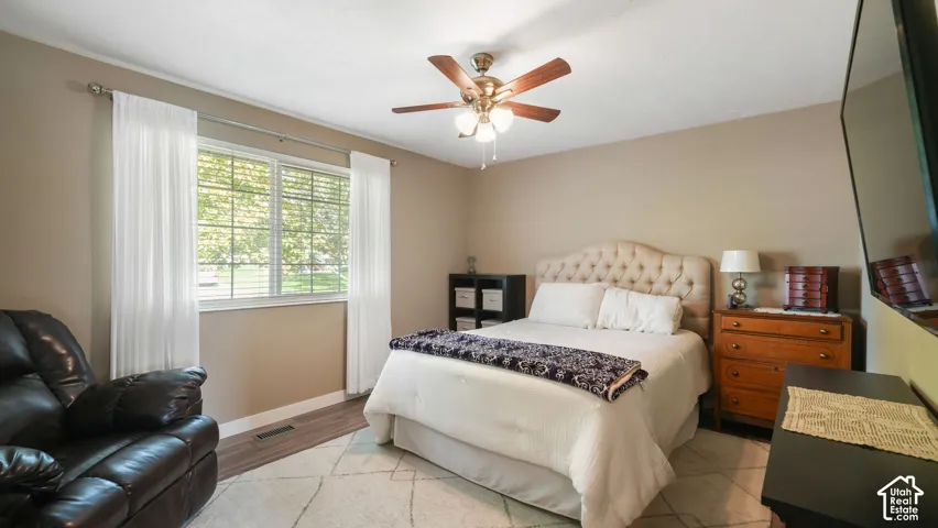 Wood-finish flooring with a ceiling fan light fixture
